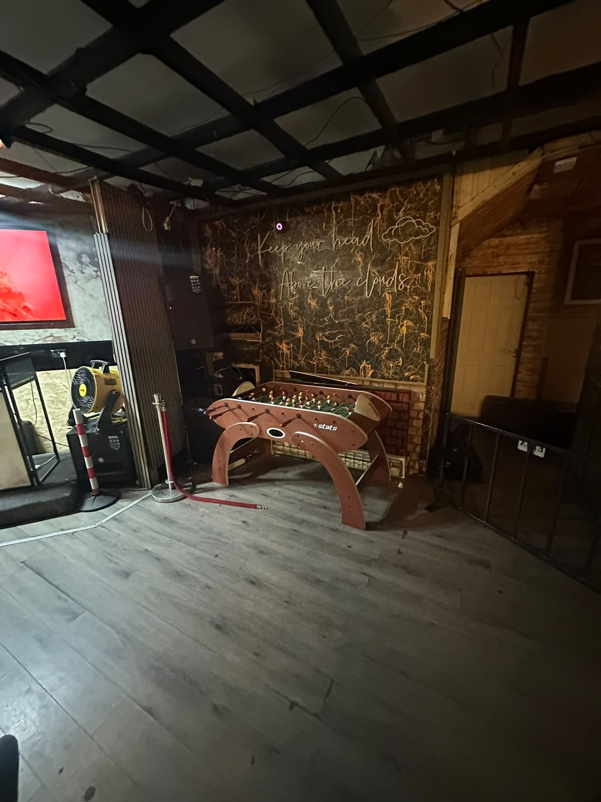 Foosball table under neon signage in the lounge